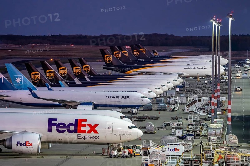 Cologne-Bonn airport, CGN, air freight center, UPS Logisic Hub, UPS cargo aircraft on the apron, FedEx and Star Air Cargo aircraft, Maersk, at the logistics center, in the evening