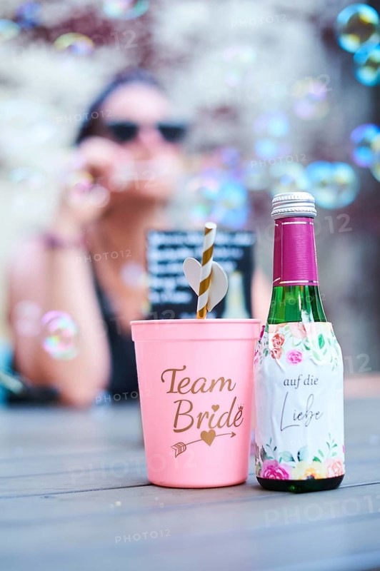 Team bride cup and a love champagne standing on a table