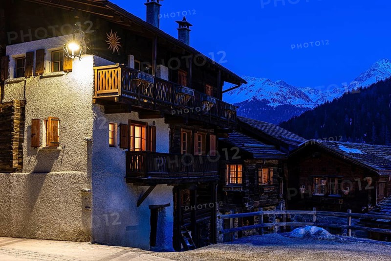 Old illuminated farmhouses in Rue du Village, night view, historic town center, Grimentz, Val d'Anniviers, Valais Alps, Canton of Valais, Switzerland