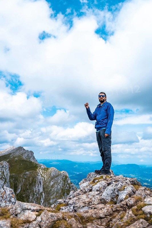 Mount Aizkorri 1523 meters, the highest in Guipúzcoa. Basque Country. Ascent through San Adrián and return through the Oltza fields. A young man in blue up on top