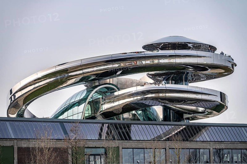 The Fenix Museum of Contemporary Art about migration, in a former warehouse on the Nieuwe Maas, walk-in spiral staircase made of polished stainless steel, in the shape of a double helix, called tornado, 550 meters long from ground floor to a viewing platform on the roof, with a view of the Rotterdam skyline, architect Ma Yansong, the Netherlands