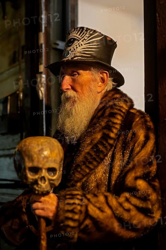 New Orleans, Louisiana - An old man on Frenchmen Street holds his cane decorated with a skull