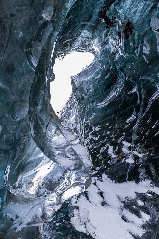Ice cave open to the top with snow-covered ice combs, Pröng ice cave, Sudurland, Iceland