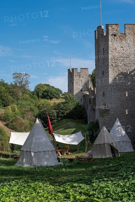 Camp in front of historic city walls with defence towers, Medieval Week, Hanseatic City of Visby, UNESCO World Heritage Site, Gotland Island, Sweden