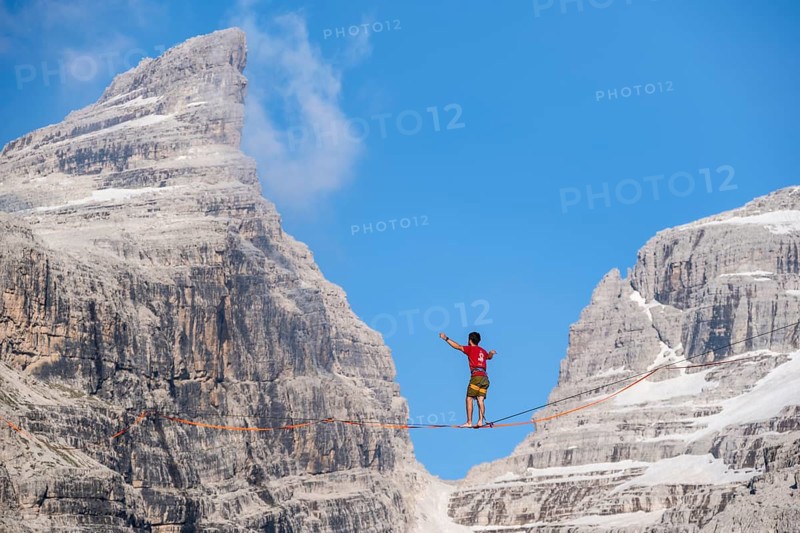 Slackliner in the mountains, mountain peaks of the Brenta Mountains, at Refugio Francis Fox Tuckett, Brenta, Brenta-Adamello Natural Park, Trentino, Italy