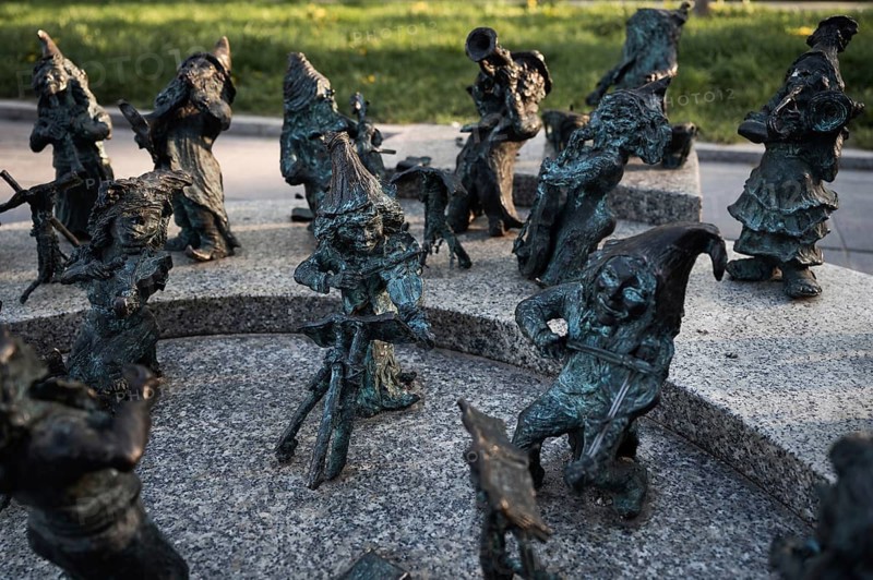 WROCLAW, POLAND - APRIL 22, 2023: Statue of dwarves representing philarmonic orchestra of Poland located in front of the building National Forum of Music.