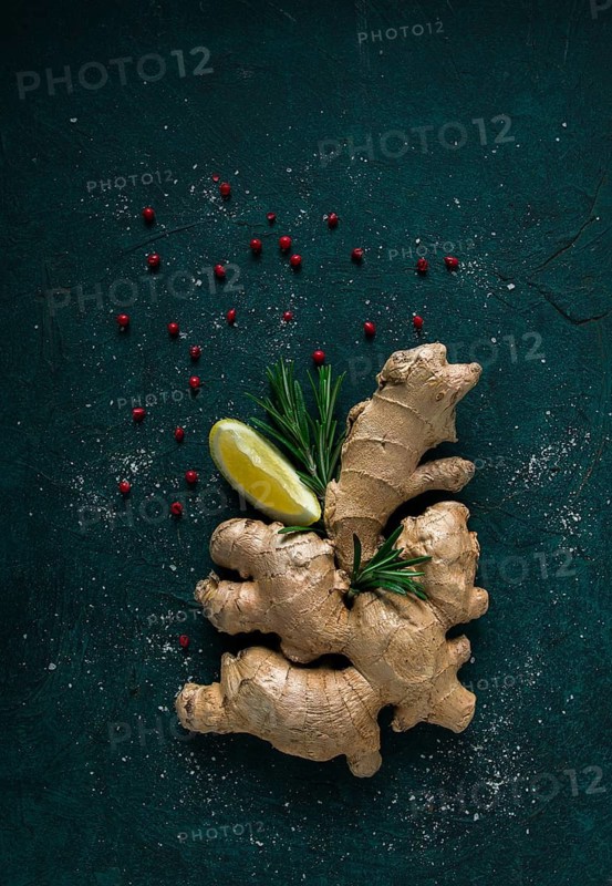 Ginger root, on a dark background, with rosemary, lemon and pepper, concept, food background, no people