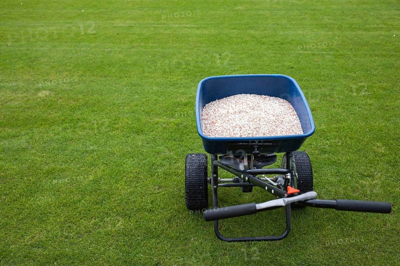 Fertilizer for grass on a football pitch. The letters marking is used to regulate the amount of fertilizer in Lubin, Poland