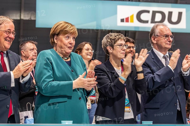 38th Federal Party Congress of the CDU of Germany in Stuttgart. Applause for Chancellor Friedrich Merz's speech. Selfie of a social media activist with former German Chancellor Angela Merkel. Bodyguards were not amused. facial expressions. Stuttgart, Baden-Württemberg, Germany