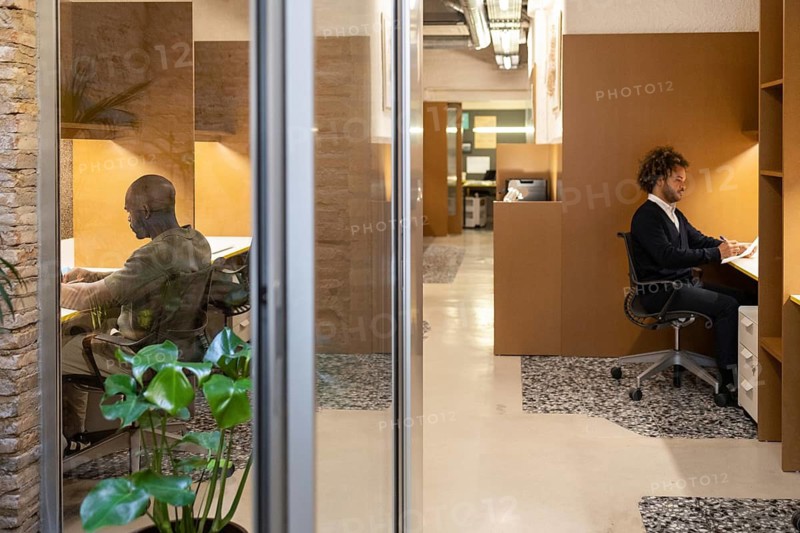 Bright and modern coworking space in Barcelona with professionals working at their desks. The environment is designed for productivity and collaboration