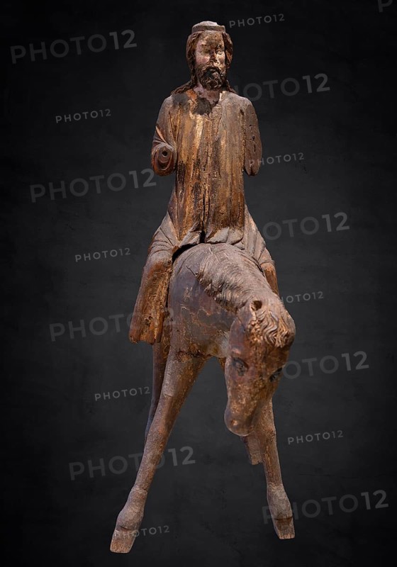 Palm tree donkey, wooden figure from around 1350, on a dark background, Diocesan Museum, Rottenburg, Baden-Württemberg, Germany