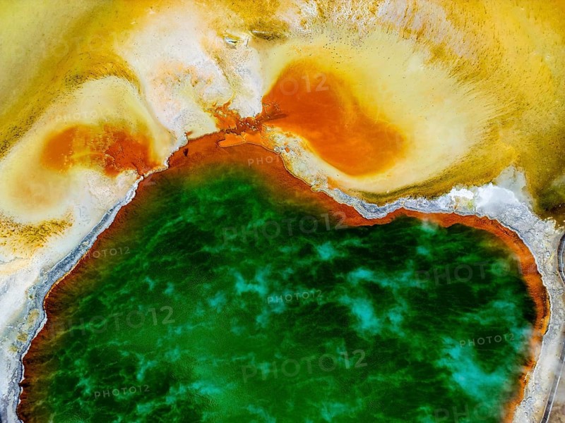 Aerial view capturing the vibrant colors and geothermal formations of Champagne Pool in Wai-O-Tapu geothermal park, New Zealand, showcasing its unique landscape and natural beauty