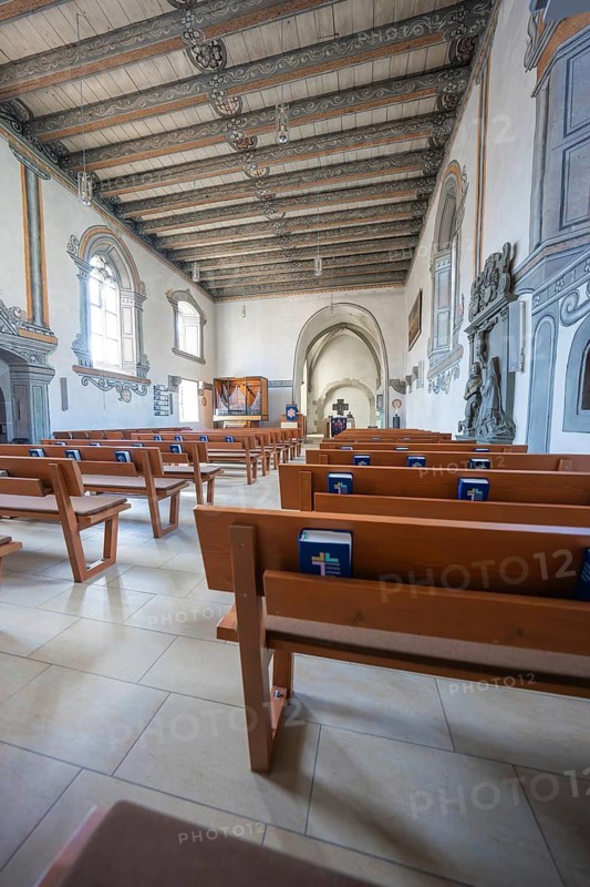 Church pews with prayer books and view of the altar area, Deufringen, Aidlingen, Böblingen district, Germany