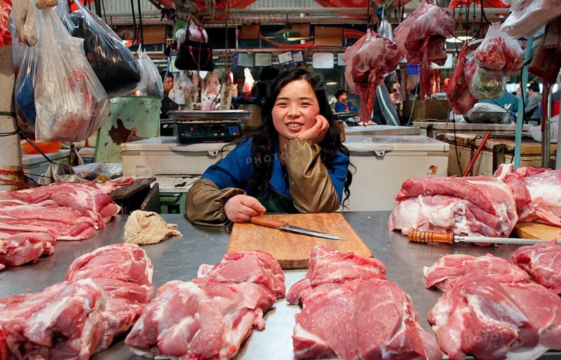 Beijing, CHN, 20.02.09 - portrait of a meat seller in a market hall for meat, fish and vegetables in Beijing, Beijing, China