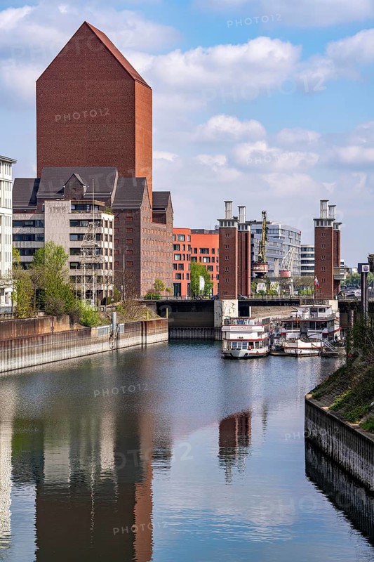 The Schwanentor Bridge in Duisburg's inner harbour, one of 3 lifting bridges, can be raised up to 10 metres, newly renovated, connects the city centre with the district of Kaßlerfeld, Ruhrort, tower of the former RWSG warehouse, now the seat of the State Archives of North Rhine-Westphalia, Germany, Schwanentor jetty, harbour cruise ships