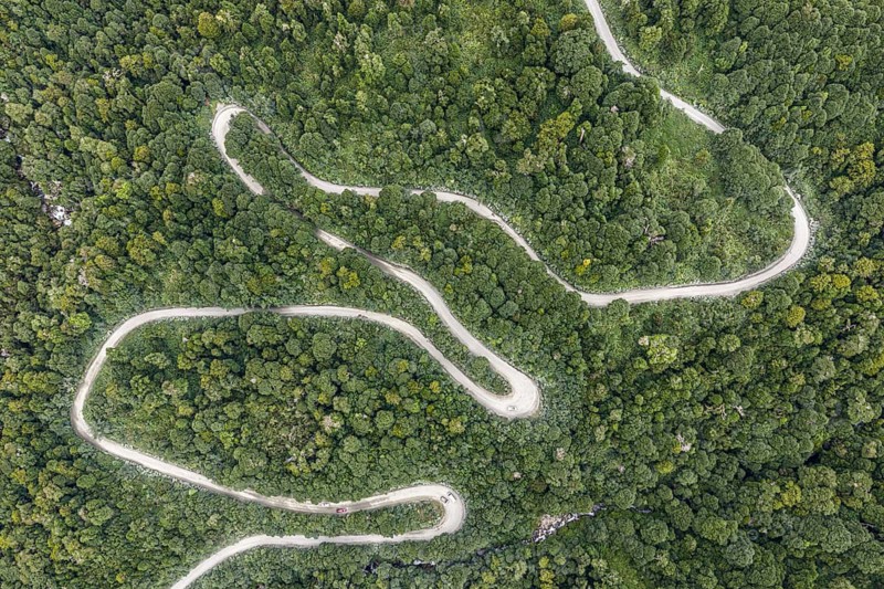 Aerial view of a winding road (Carretera Austral) through dense forest, south of Puyuhuapi, Aysén Region, Chile