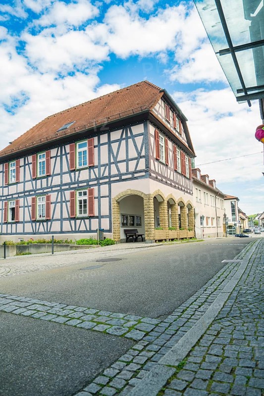 View of a traditional half-timbered house on a quiet street under a blue sky, Knittlingen, Germany