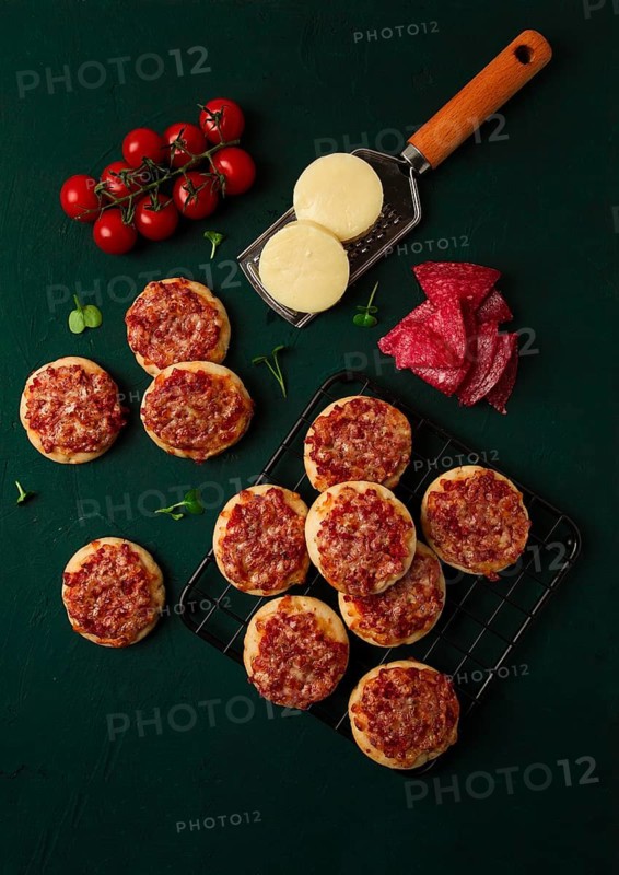 Mini pizzas, salami with mozzarella cheese, on the table, top view, no people