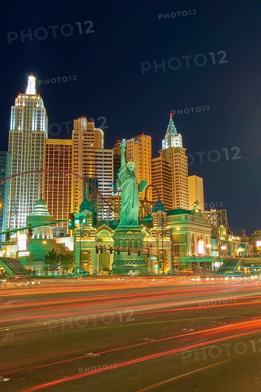 Nighttime urban scene in Las Vegas with brightly lit New York-New York Hotel and Casino, the Strip, street, Las Vegas, Nevada, USA