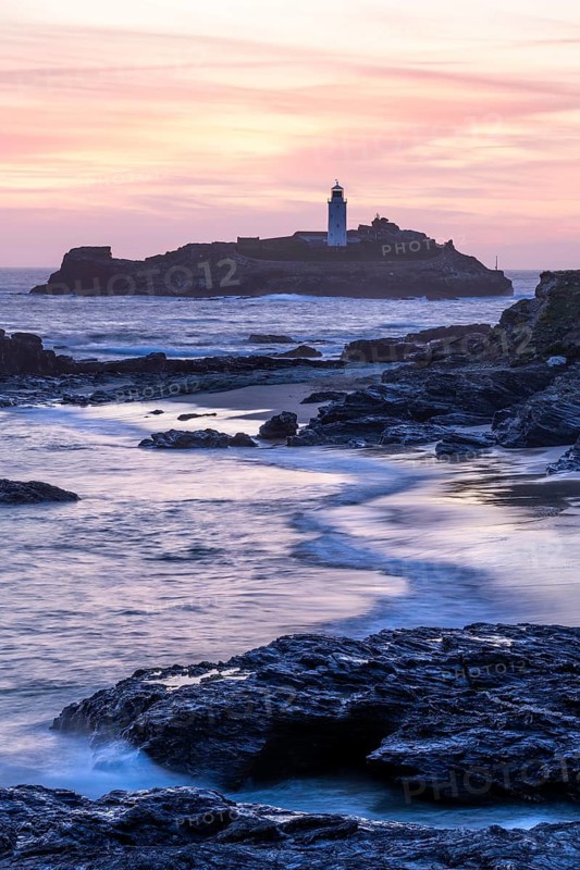 Godrevy Lighthouse, the lighthouse of Godrevy on Godrevy Island. In the evening at sunset. Long exposure. Cornwall, England, Great Britain