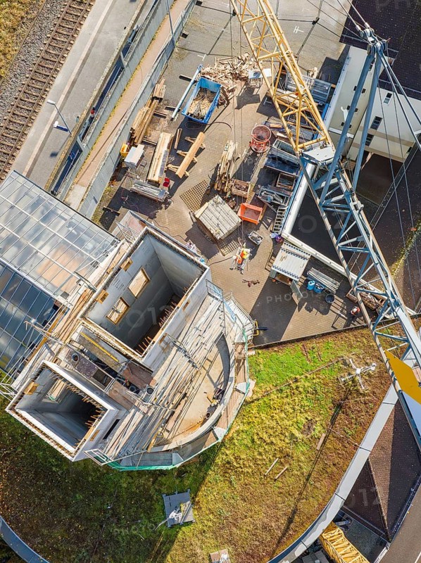 Bird's eye view of the construction site, workers and materials on the ground, extension of the Calw railway station for the new track of the Hermann Hessebahn, Calw, Black Forest, Germany