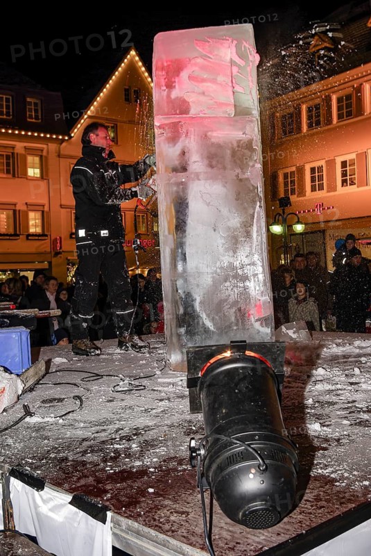 An ice sculpture is being created: ice carving street action as part of the long shopping night in the city center of Reutlingen, Baden-Württemberg, Germany, for editorial use only