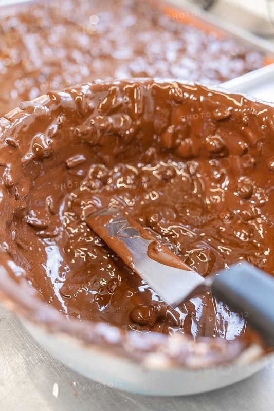 A large bowl of melted chocolate with a spatula, Burch Schokolade production, Haselstaller Hof, Gechingen, Germany