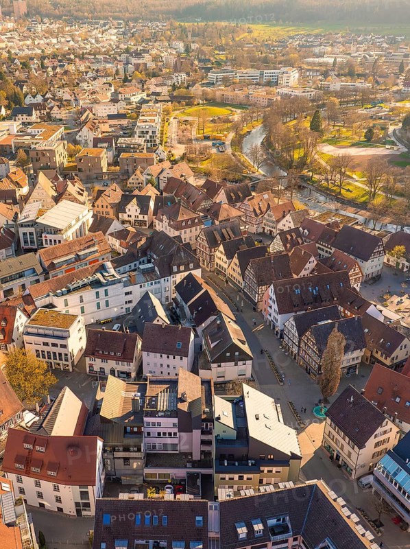 Aerial view of an old town with terraced houses and a river at dusk, Nagold, Black Forest, Germany