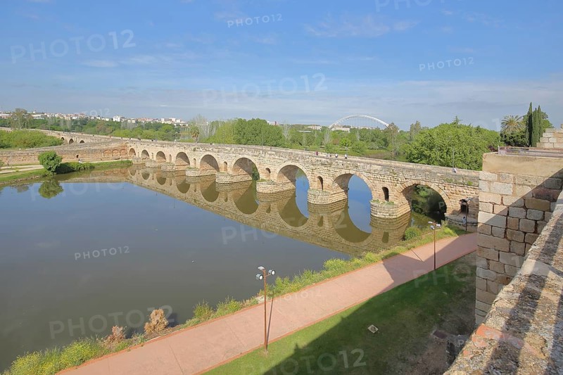 UNESCO Puente Romano as part of the Roman city of Emerita Augusta with reflection in the Rio Guadiana river, stone arch bridge, Roman Forum, Merida, Extremadura, Spain