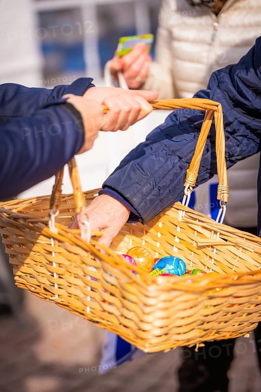 Person handing over Easter basket with colorful eggs outdoors, Easter campaign, Sindelfingen, Böblingen district, Germany