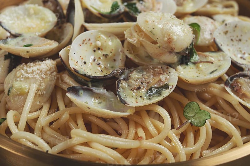 Spaghetti with vongole clams, in cream sauce, carbonara, in a brass pan, homemade, top view, no people
