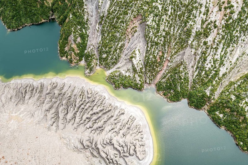 Lake with sandbank and dead trees, crater rim of chaiten volcano, aerial view, Patagonia, Chile