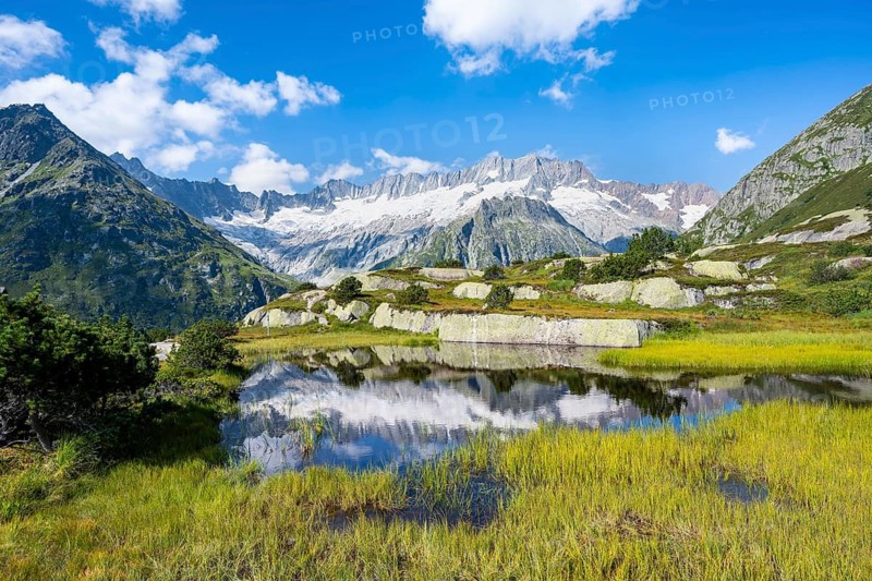 Picturesque mountain landscape, dammastock and damma glaciers reflected in Moorsee, Göscheneralp, Canton of Uri, Switzerland