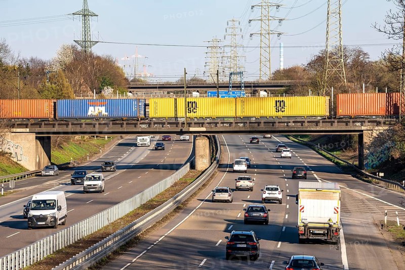 Freight train crosses the A42 motorway at Oberhausen-Zentrum on a railway bridge, the railway line comes from or goes to the OB-Osterfeld marshalling yard, busy cargo train line, North Rhine-Westphalia, Germany