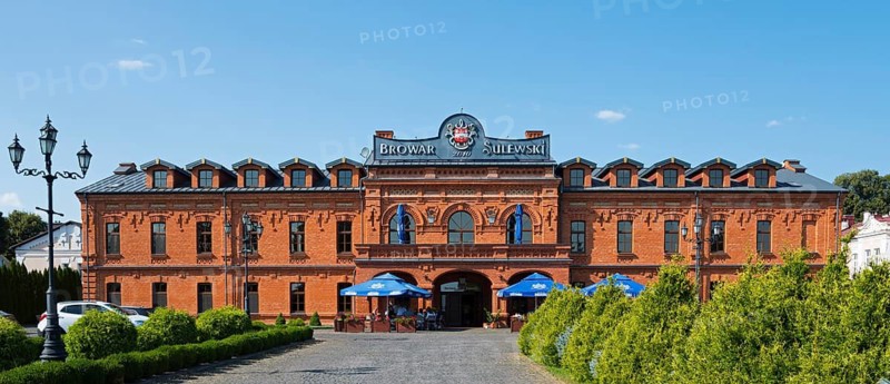 Historic brick building with brewery and restaurant in sunny weather, Sulewski Brewery, Hrubieszów, Hrubieszow, Hrubieszowski Province, Lublin Voivodeship, Poland