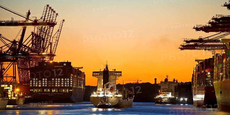 Container ships at the Eurogate container terminal in the evening with an atmospheric sunset, harbour, Hamburg, Germany