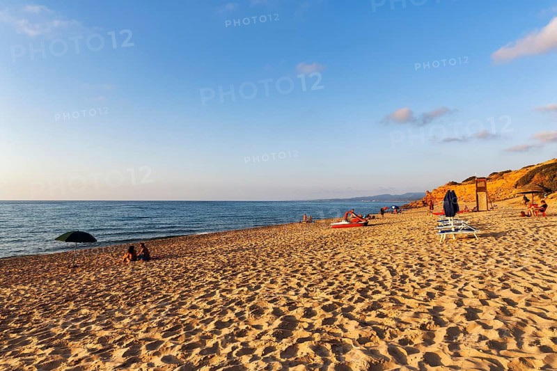 Tourists on the sandy beach, red rocks, holiday by the sea, Spiaggia di Scivu, Arbus, Costa Verde, Sud Sardegna, Sardinia, Italy