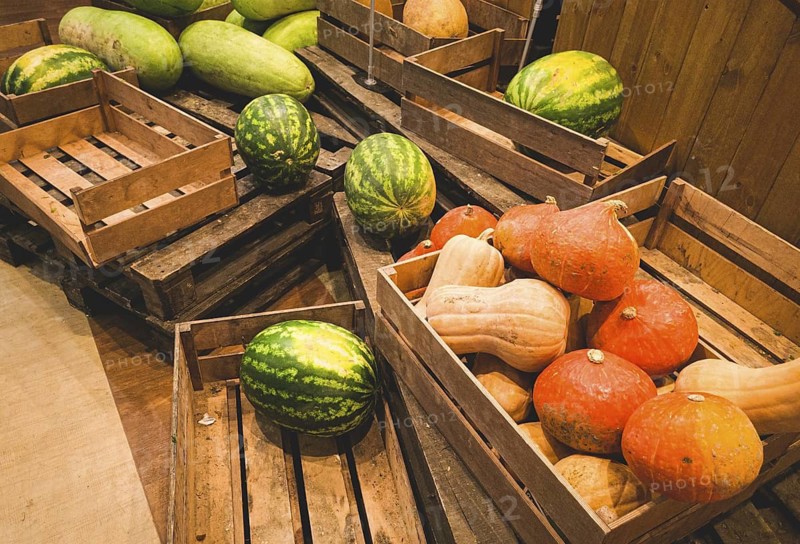 Watermelons and pumpkins, in a wooden box, on pallets, supermarket, lifestyle, no people, mobile photo