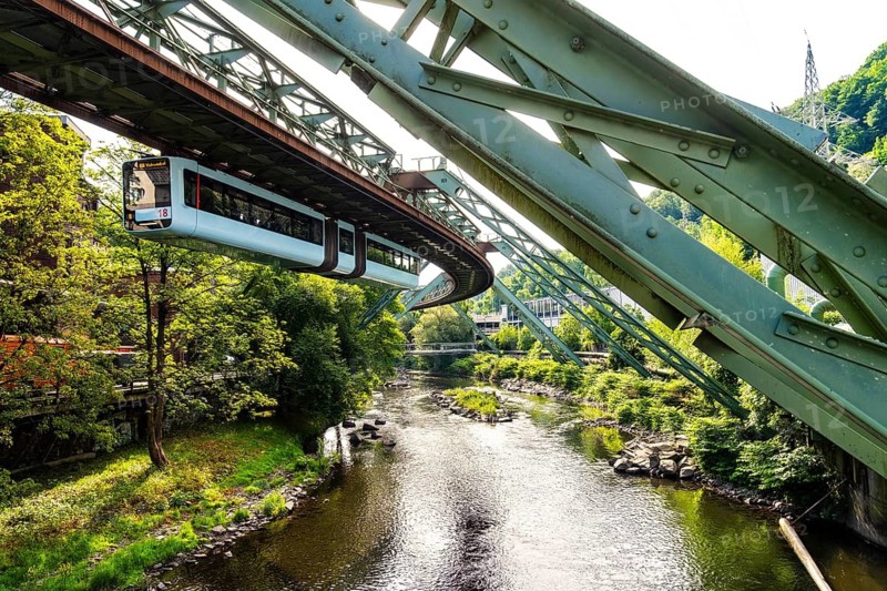 The Wuppertal suspension railway runs through a historic district and industrial area near the Westende stop in Wuppertal, Germany