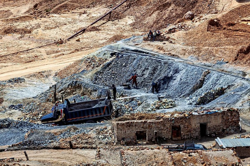 Workers in an open mine accompanied by a truck, rugged terrain, The Potosi silver mines on Cerro Rico in Bolivia