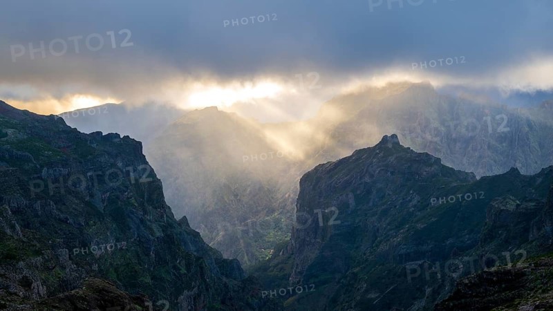 Sunset at Pico do Arieiro, sun shining through clouds, sunbeam, hiking trail PR1, Madeira, Portugal
