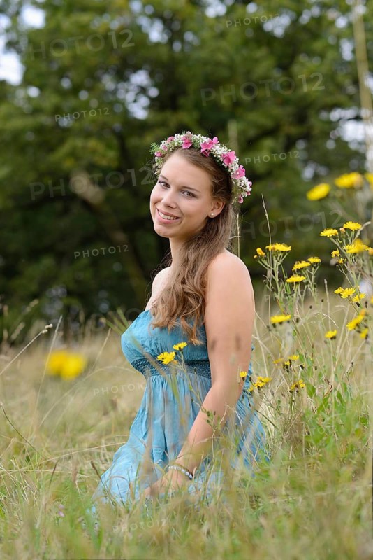 Young woman with a floral wreath in her hair outdoors, Germany