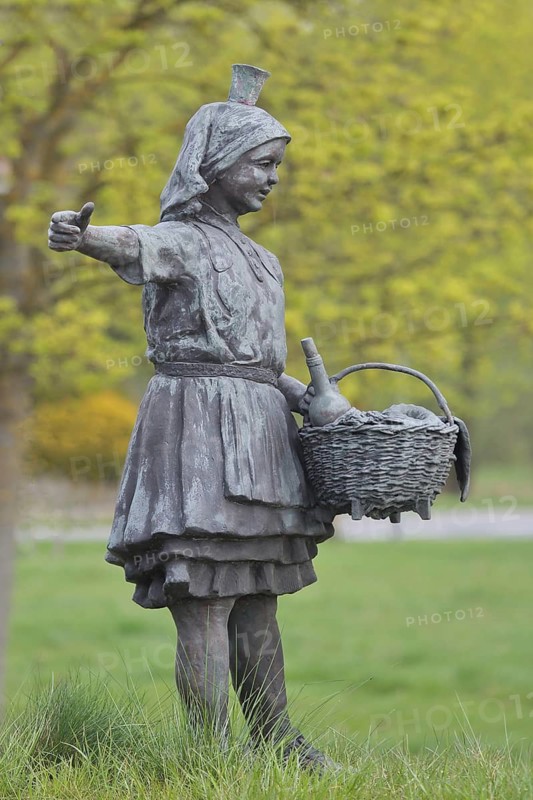 Little Red Riding Hood sculpture by Ewald Rumpf 2010, modern art, bronze sculpture, girl with wicker basket and traditional costume, gesture, arm stretching, fairy tale figure, German Fairytale Route, Remsfeld, Knüllwald, Knüllgebirge, Hesse, Germany