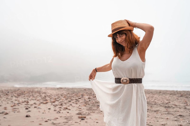 Cute woman in summer clothes on a bay of water in Cabo de Gata, Spain