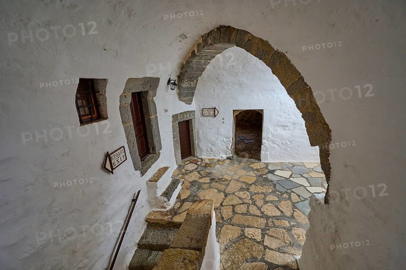 Interior of a historic monastery with stone arches and rustic elements, Inside the monastery, Agiou Theologou Monastery, Chora, Patmos, Dodecanese, Greek Islands, Greece