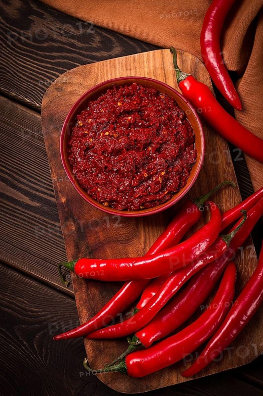 Red, Hot sauce, chili pepper, on a wooden table, no people, vertical, top view