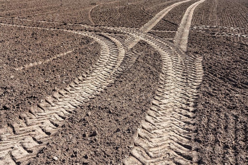 Tractor tracks, agricultural trails at a cultivated field in springtime, farmland near Wesertal, Weser Uplands, Weserbergland, Hesse, Germany