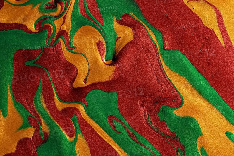 A textured background showcasing swirling patterns of metallic red, green, and yellow paints, ideal for dynamic and eye-catching projects