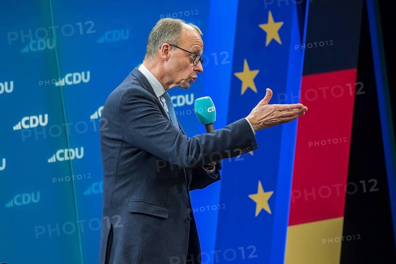 Election event of the CDU party for the Bundestag elections with top candidate Friedrich Merz. Portrait in front of the German flag and the flag of the European Union. Singen am Hohentwiehl. Baden-Württemberg, Germany