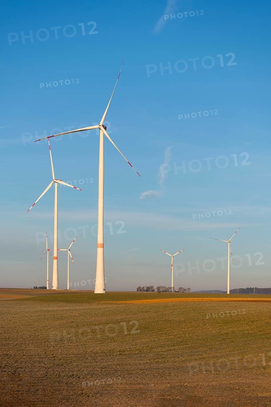 Wind turbines in an open green landscape under a calm sky, solar park, near Ulm, Swabian Alb, Baden-Württemberg, Germany